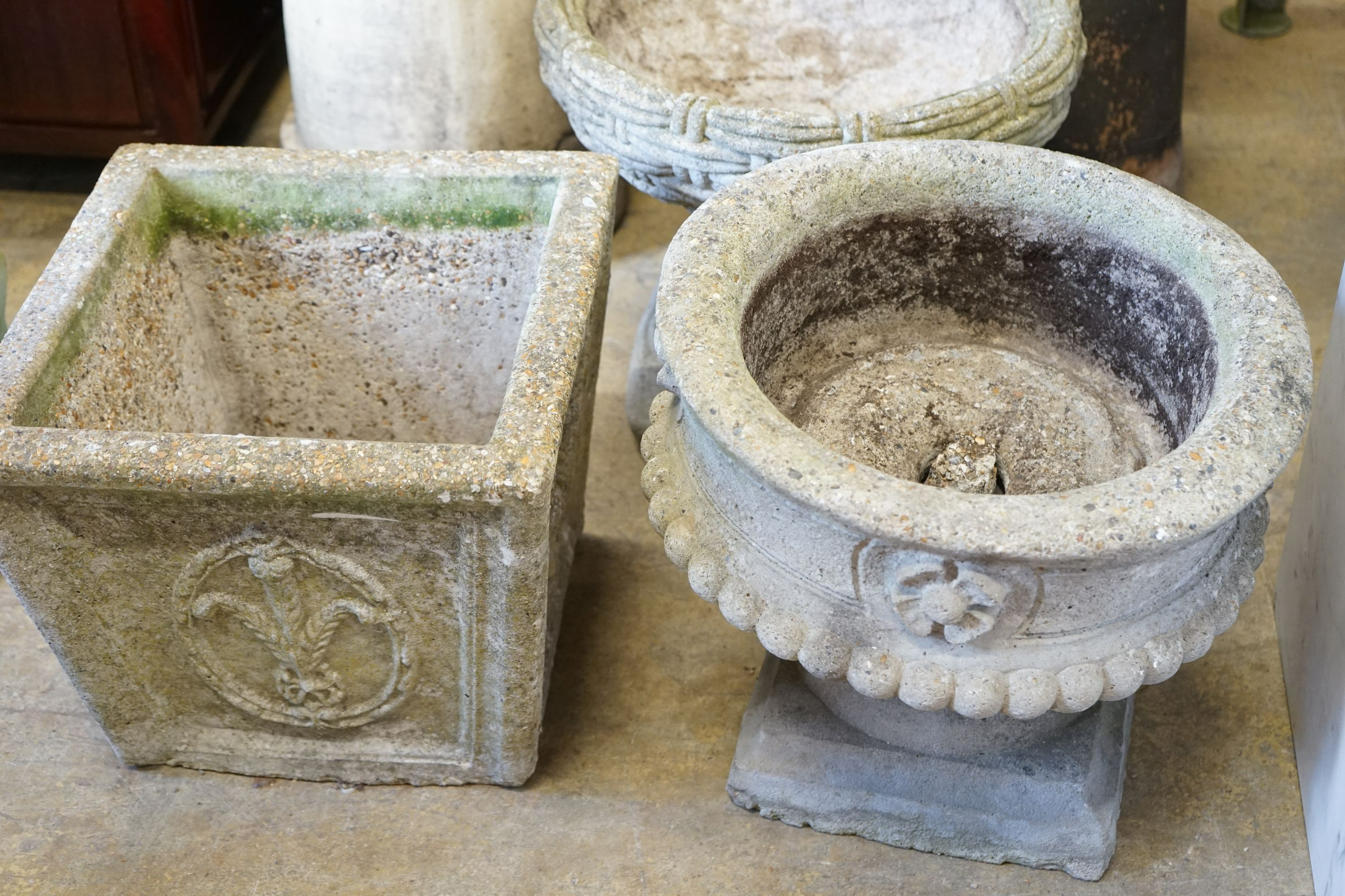 A group of three reconstituted stone garden planters, largest diameter 40cm, height 36cm